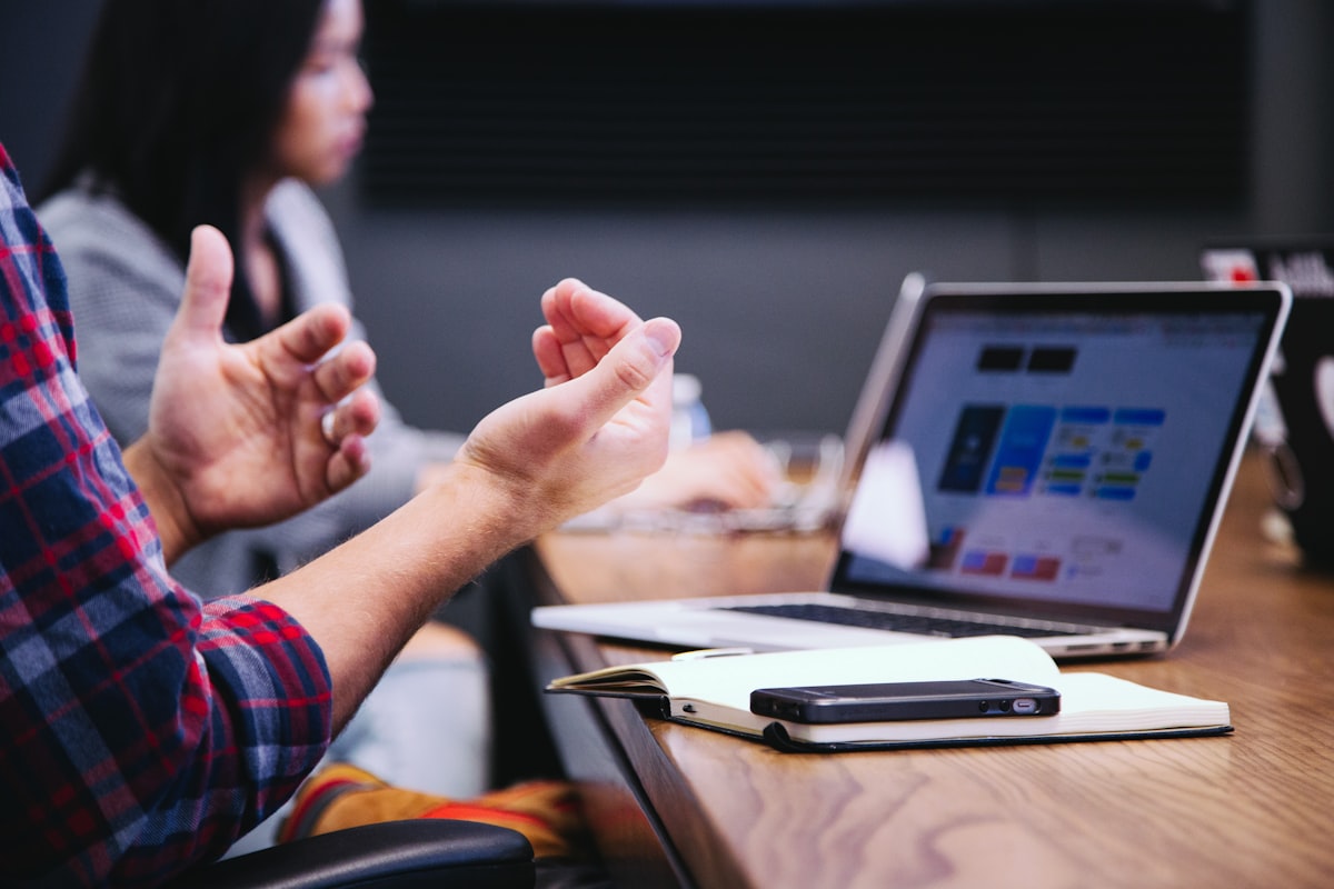 Person overwhelmed by multiple browser tabs and documents — the challenge of manual policy monitoring