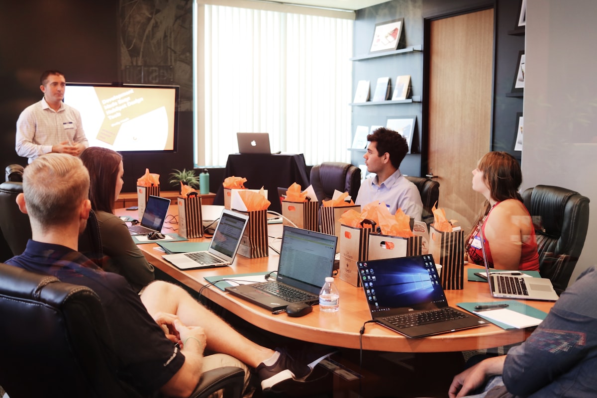 Professionals reviewing policy documents at a conference table — the kind of strategic meeting where trade association positions are developed before they reach government